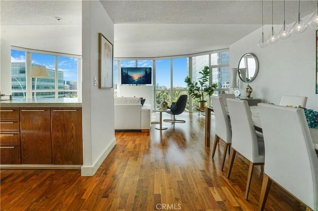 3141 Michelson Dr Unit 508, Irvine, CA 92612 - living room with wood finished floors, healthy amount of natural light, baseboards, and a textured ceiling