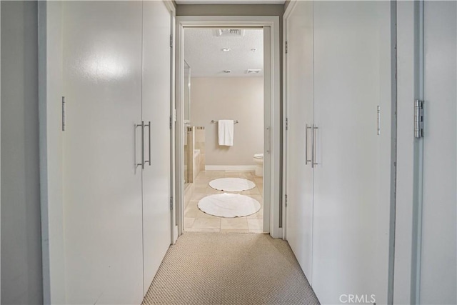 hallway featuring light tile patterned floors