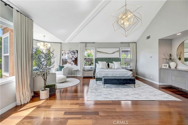 bedroom featuring baseboards, an inviting chandelier, wood finished floors, and visible vents