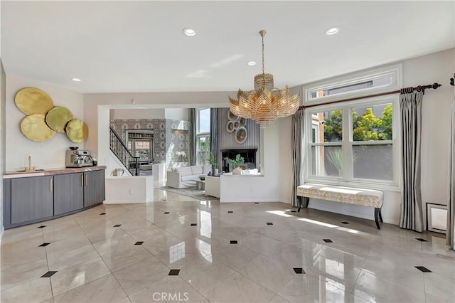 dining room with recessed lighting, an inviting chandelier, and a fireplace