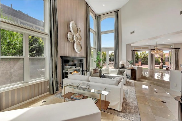 living area with plenty of natural light and a towering ceiling