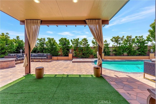 view of swimming pool featuring a fenced in pool, a fire pit, a fenced backyard, and a patio area