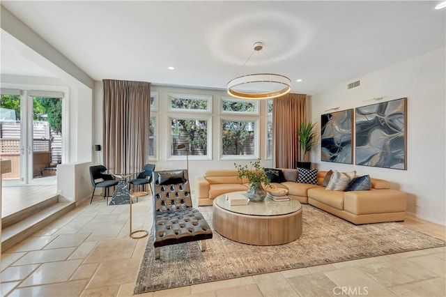 living room with recessed lighting, baseboards, visible vents, and stone tile flooring