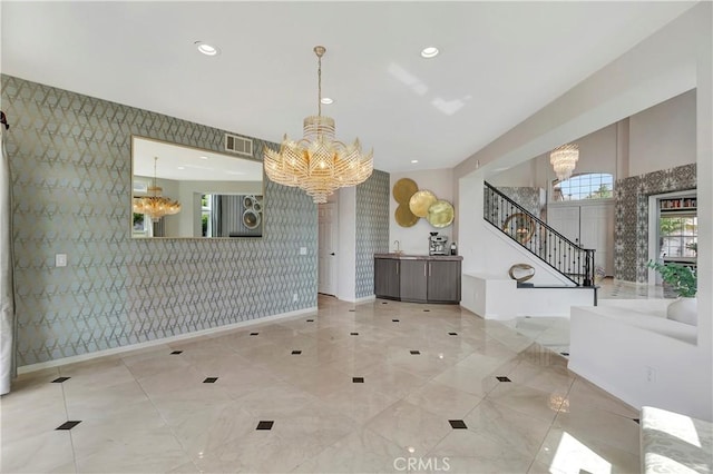 dining space with visible vents, stairs, baseboards, a notable chandelier, and wallpapered walls