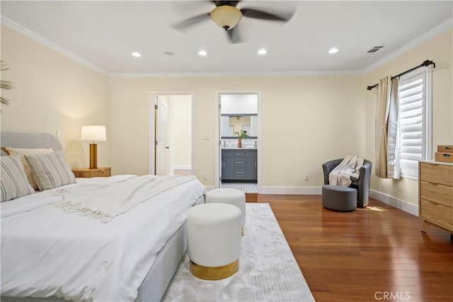 bedroom with crown molding, recessed lighting, wood finished floors, and visible vents