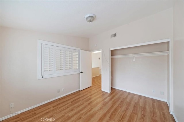 1101 Portofino Ct Unit 103, Corona, CA 92881 - unfurnished bedroom with wood finished floors, baseboards, and a closet