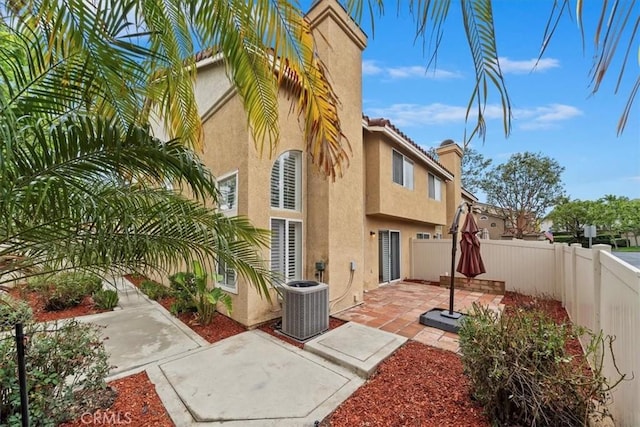 1101 Portofino Ct Unit 103, Corona, CA 92881 - back of house with stucco siding, a patio, and a fenced backyard