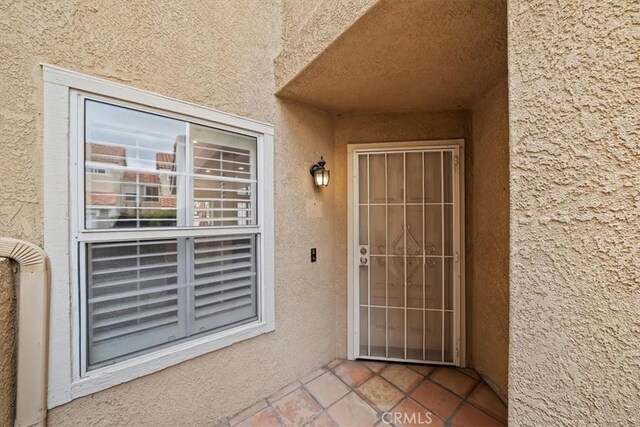 1101 Portofino Ct Unit 103, Corona, CA 92881 - doorway to property featuring stucco siding