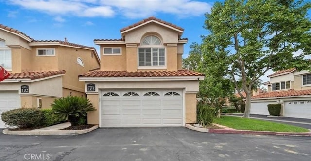 1101 Portofino Ct Unit 103, Corona, CA 92881 - mediterranean / spanish-style home featuring driveway, stucco siding, a garage, and a tiled roof