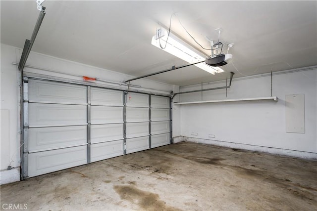 garage with a garage door opener and electric panel