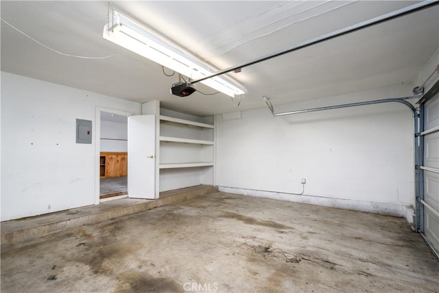 garage with a garage door opener and electric panel