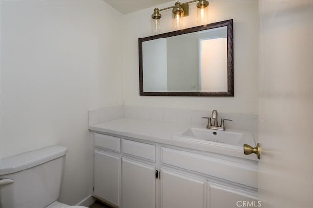 bathroom with toilet and vanity