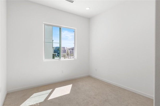 unfurnished room featuring baseboards and carpet