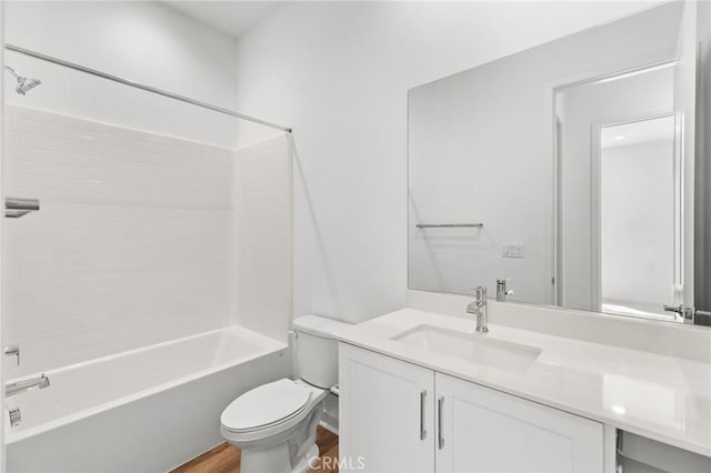 full bathroom with wood finished floors, toilet, shower / bathing tub combination, and vanity