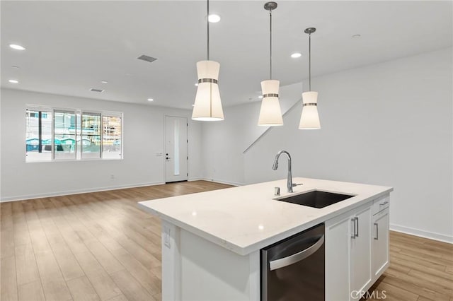 kitchen with visible vents, a sink, light wood finished floors, and dishwasher