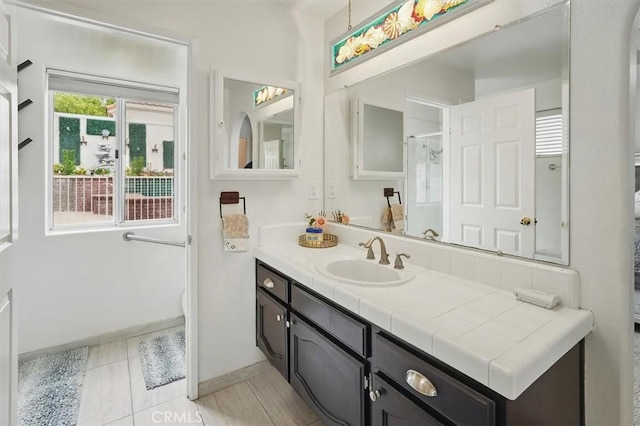 full bathroom with baseboards and vanity