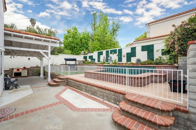 exterior space featuring a swimming pool, a patio area, and fence