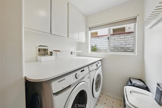 clothes washing area featuring independent washer and dryer, baseboards, light floors, and cabinet space