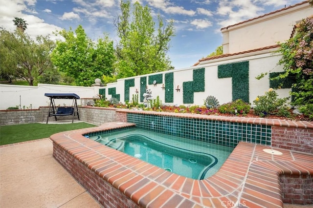view of swimming pool with fence and a patio area
