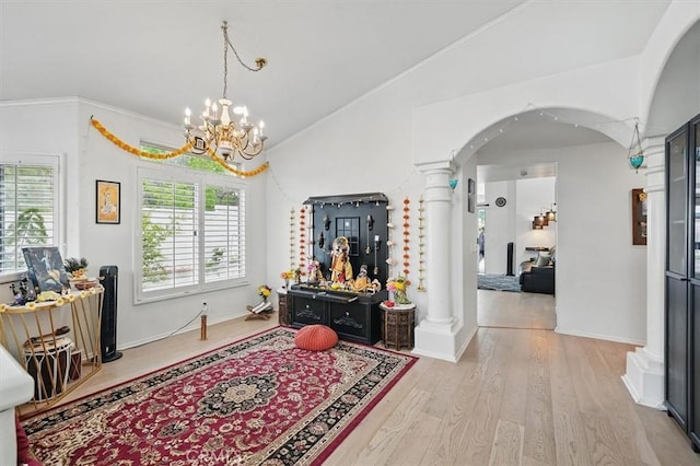 interior space with arched walkways, lofted ceiling, ornate columns, and a chandelier