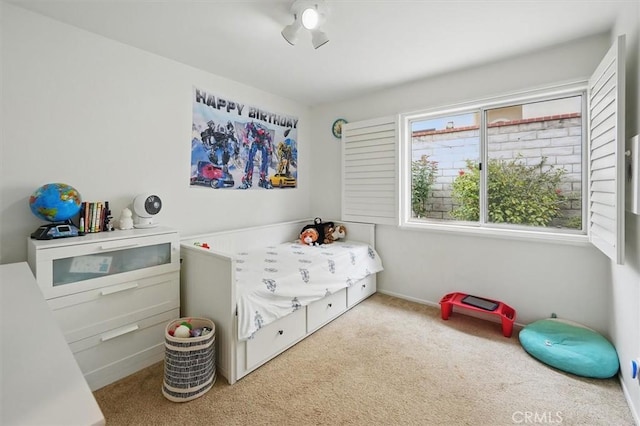 bedroom featuring carpet floors and baseboards