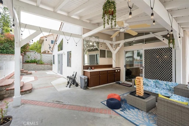 view of patio / terrace with ceiling fan, fence, and an outdoor living space
