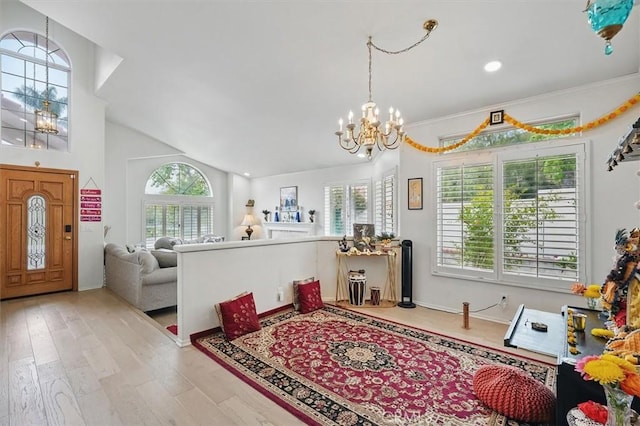 interior space featuring a chandelier, wood finished floors, and lofted ceiling