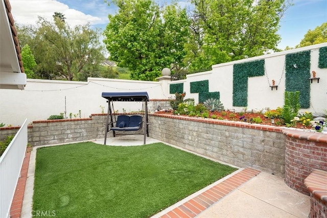 view of yard with a fenced backyard and a patio