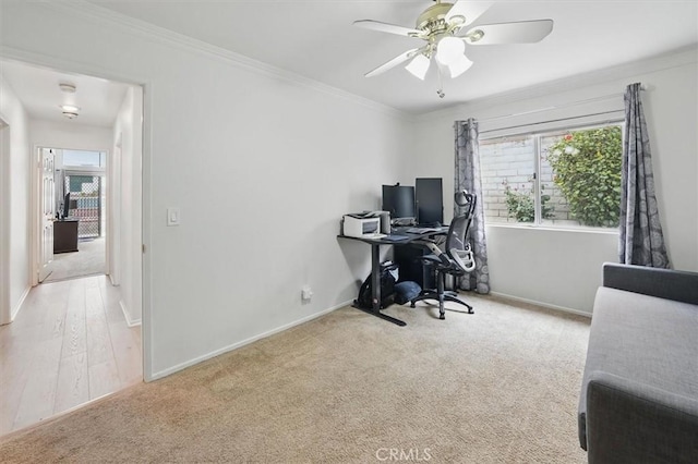 home office with a ceiling fan, baseboards, a healthy amount of sunlight, and carpet