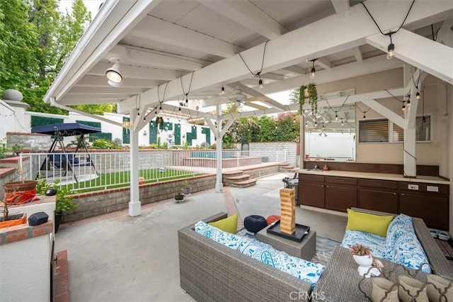 view of patio featuring fence, an outdoor hangout area, and ceiling fan