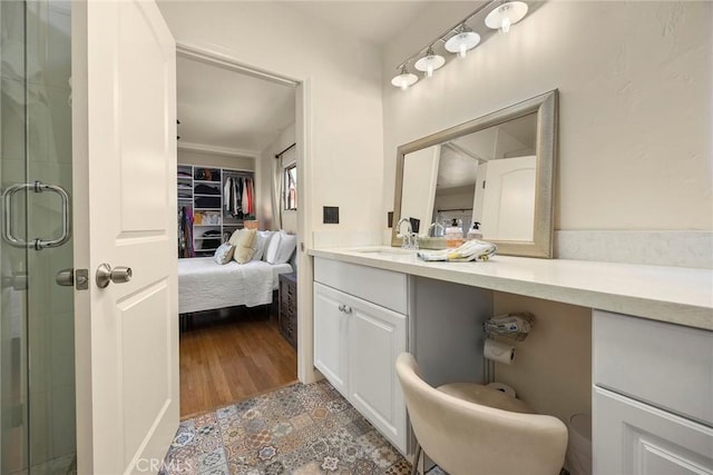 full bath with vanity and a shower stall