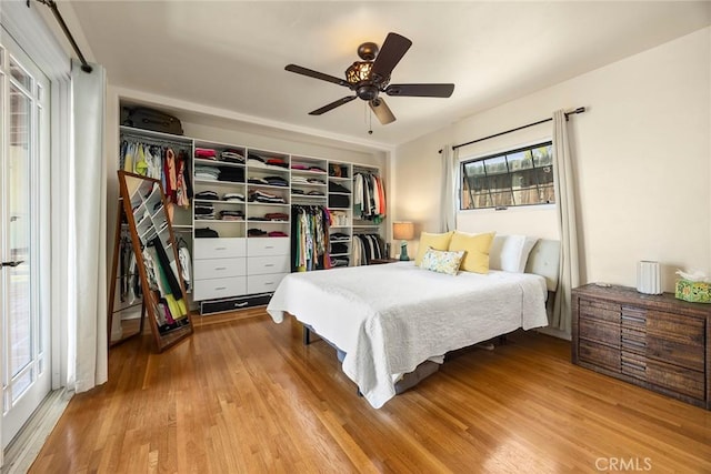 bedroom with a ceiling fan and wood finished floors