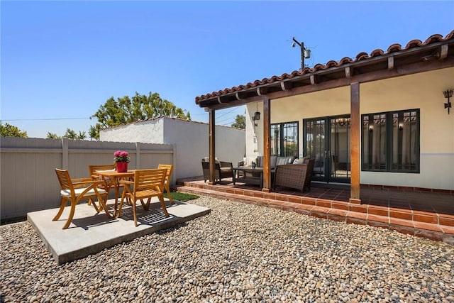 exterior space featuring fence, outdoor lounge area, and a patio