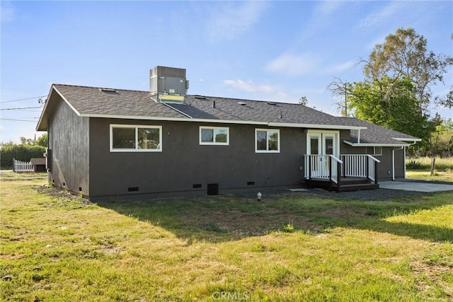 back of house with central AC unit, a shingled roof, a yard, and crawl space