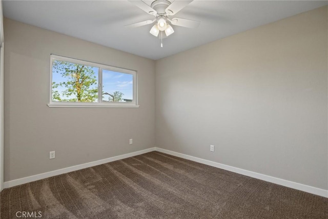 empty room with baseboards, a ceiling fan, and dark colored carpet