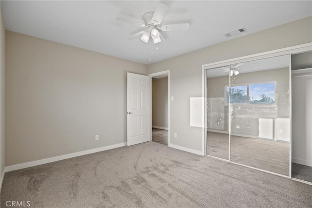 unfurnished bedroom with carpet flooring, ceiling fan, baseboards, visible vents, and a closet