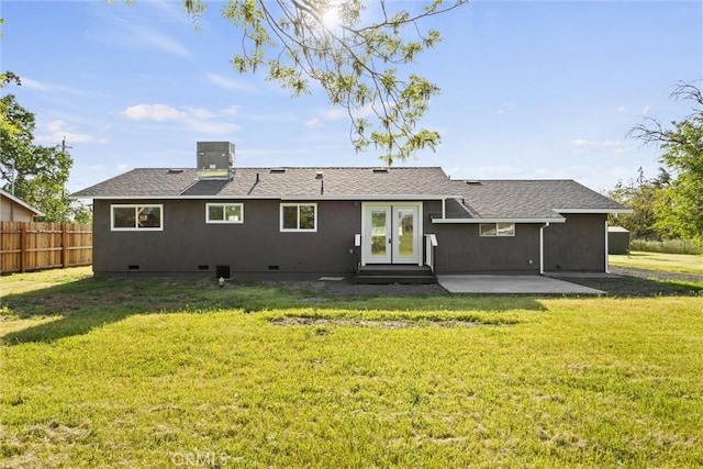 rear view of house featuring a lawn, a patio area, fence, and crawl space