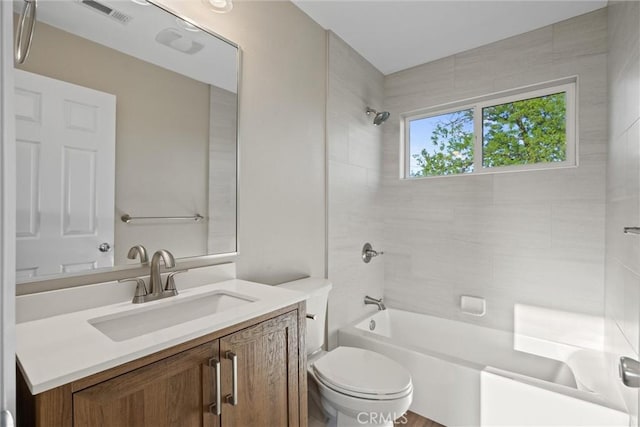 full bath featuring visible vents, vanity, toilet, and shower / washtub combination