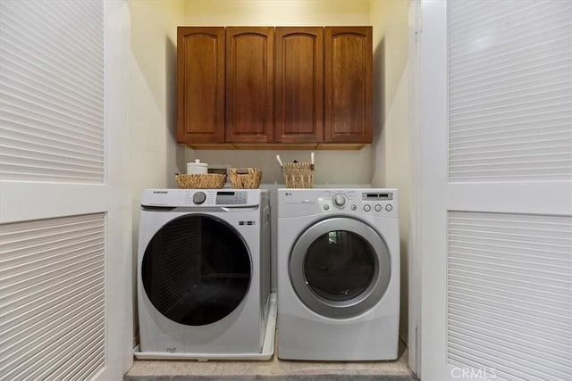 laundry room featuring cabinet space and independent washer and dryer
