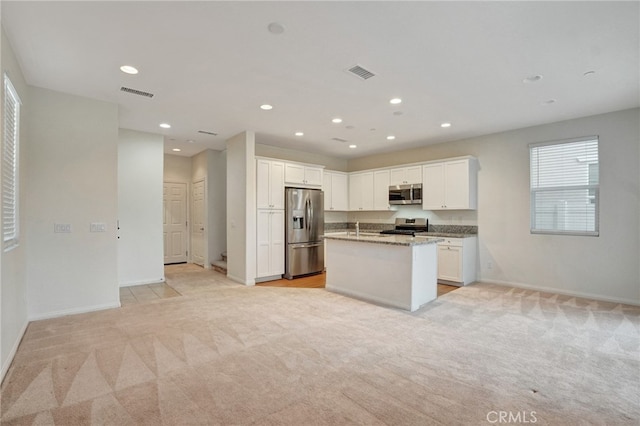 22824 W Olive Way, Canoga Park, CA 91304 - kitchen with appliances with stainless steel finishes, baseboards, light colored carpet, and visible vents