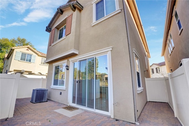 22824 W Olive Way, Canoga Park, CA 91304 - back of house featuring fence, a patio, stucco siding, and central air condition unit
