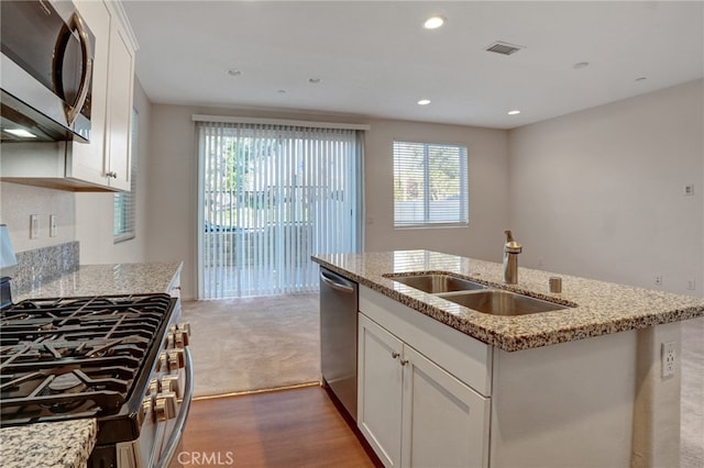 22824 W Olive Way, Canoga Park, CA 91304 - kitchen with white cabinets, light stone counters, a sink, a kitchen island with sink, and stainless steel appliances