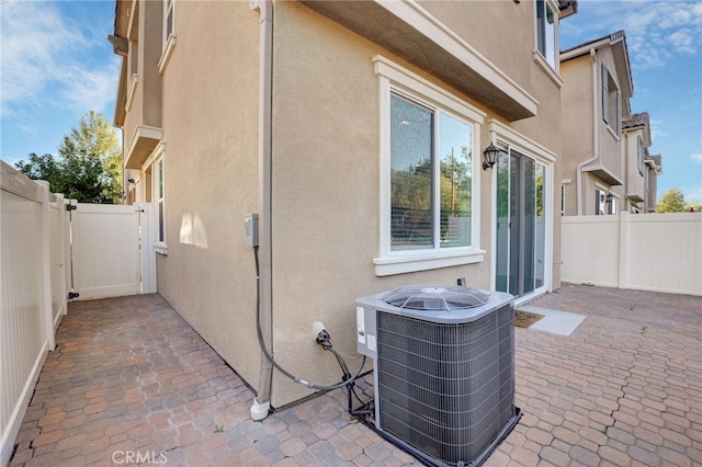 22824 W Olive Way, Canoga Park, CA 91304 - view of side of property featuring stucco siding, a fenced backyard, a patio area, and central AC