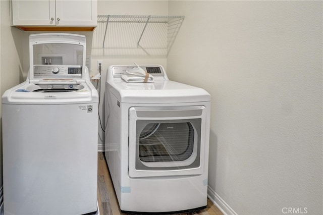22824 W Olive Way, Canoga Park, CA 91304 - washroom with separate washer and dryer, baseboards, and cabinet space