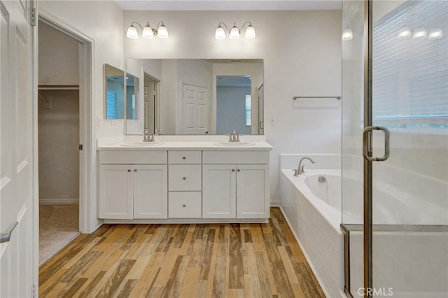 22824 W Olive Way, Canoga Park, CA 91304 - bathroom featuring double vanity, a sink, a bath, and wood finished floors