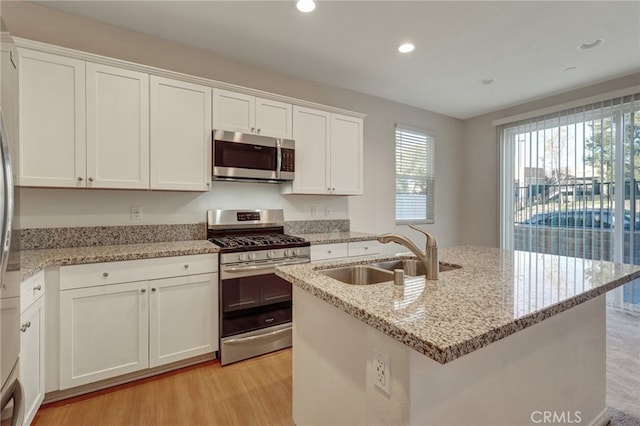 22824 W Olive Way, Canoga Park, CA 91304 - kitchen with appliances with stainless steel finishes, a sink, light wood-style floors, white cabinetry, and recessed lighting