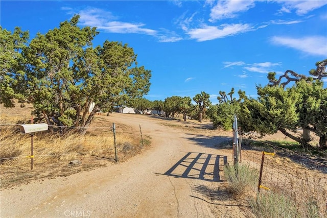 10634 Mesquite St, Oak Hills, CA 92344 - view of road featuring a rural view and dirt driveway