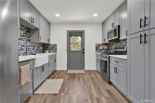 10634 Mesquite St, Oak Hills, CA 92344 - kitchen featuring stainless steel appliances, gray cabinets, and a sink