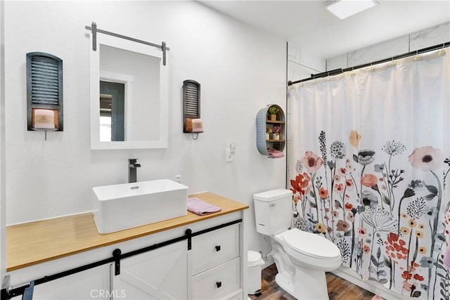 10634 Mesquite St, Oak Hills, CA 92344 - full bathroom featuring vanity, a shower with curtain, toilet, and wood finished floors