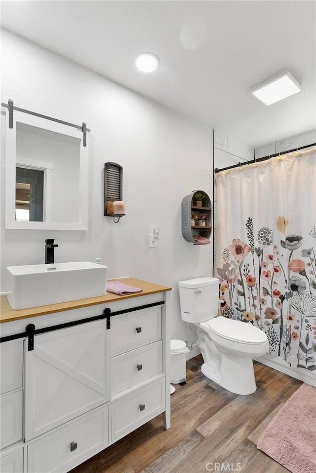10634 Mesquite St, Oak Hills, CA 92344 - bathroom with vanity, a shower with curtain, toilet, and wood finished floors